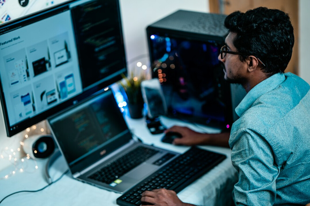 programmer working on laptop at desk