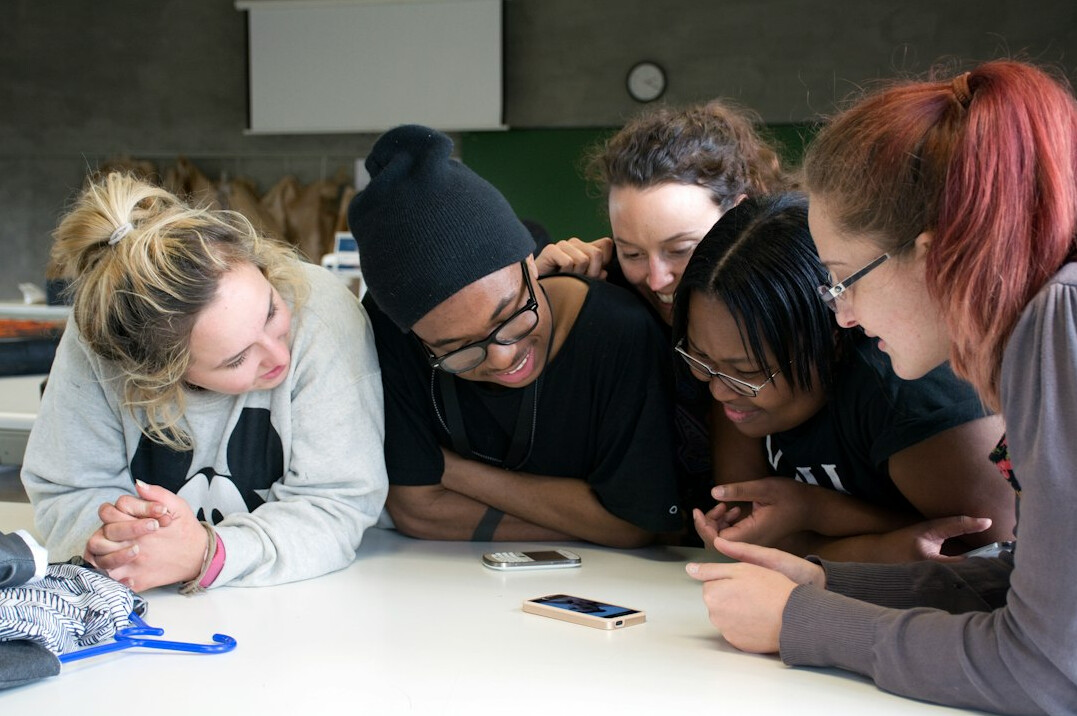 diverse students coding in classroom