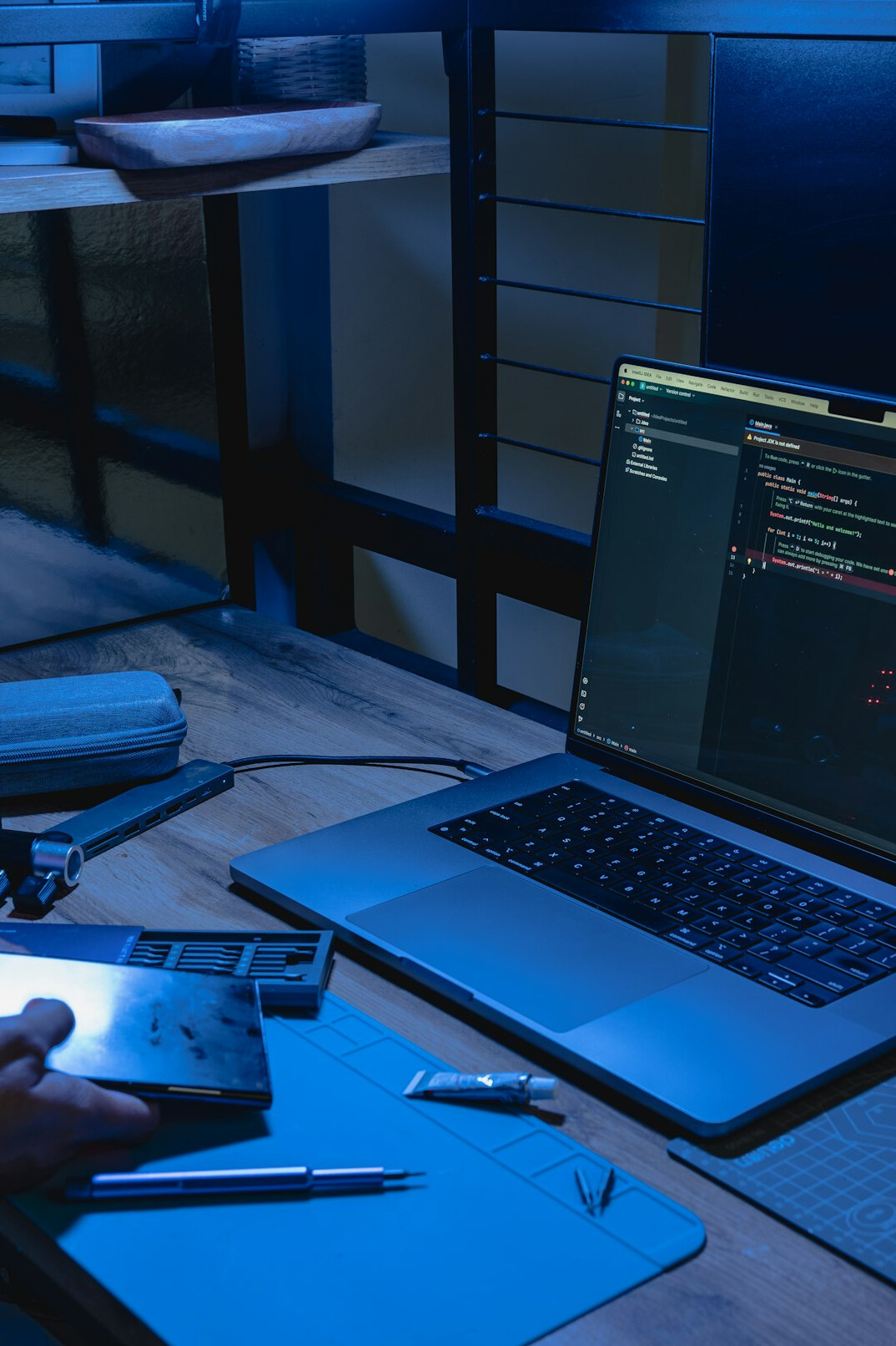 person coding on laptop at desk