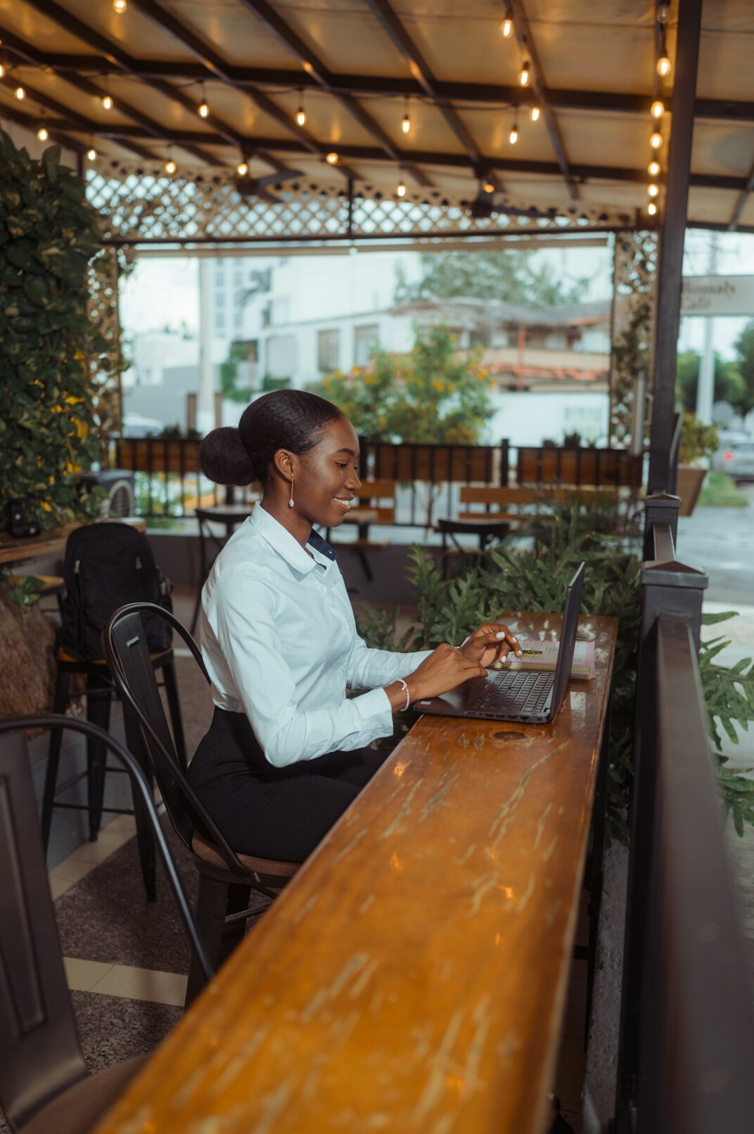 woman coding on laptop at cafe