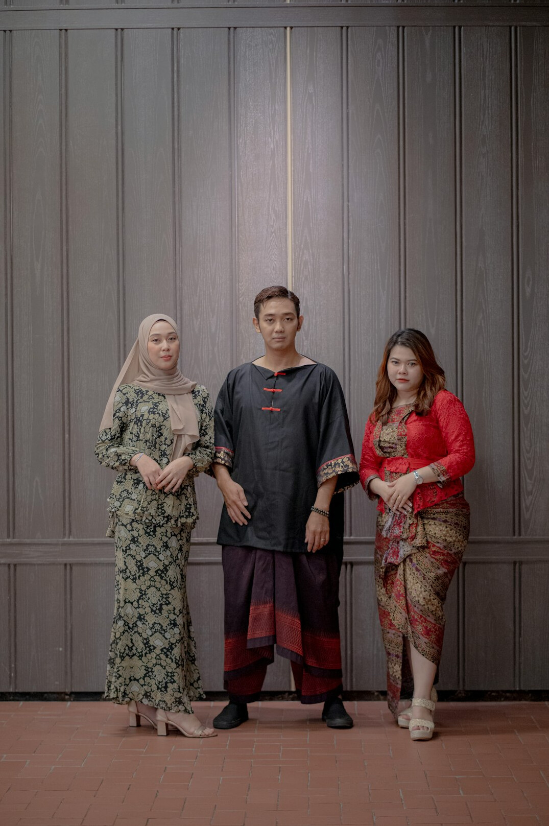 Group portrait of four Malaysian professionals from diverse ethnic backgrounds standing together