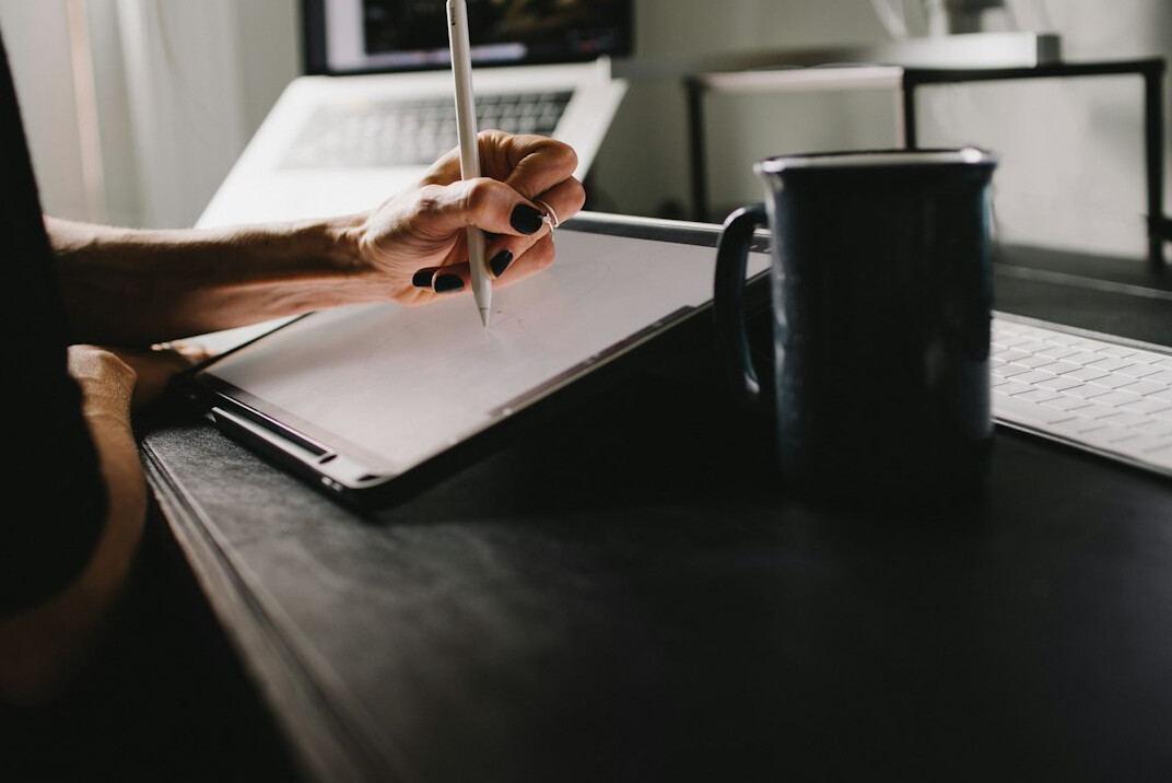 person writing notes at desk